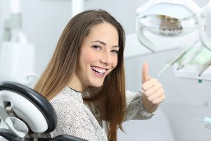 Teen with thumbs up after wisdom teeth removal